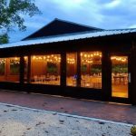 Barn lit at dusk — garden wedding venue in Miami with romantic bistro lights